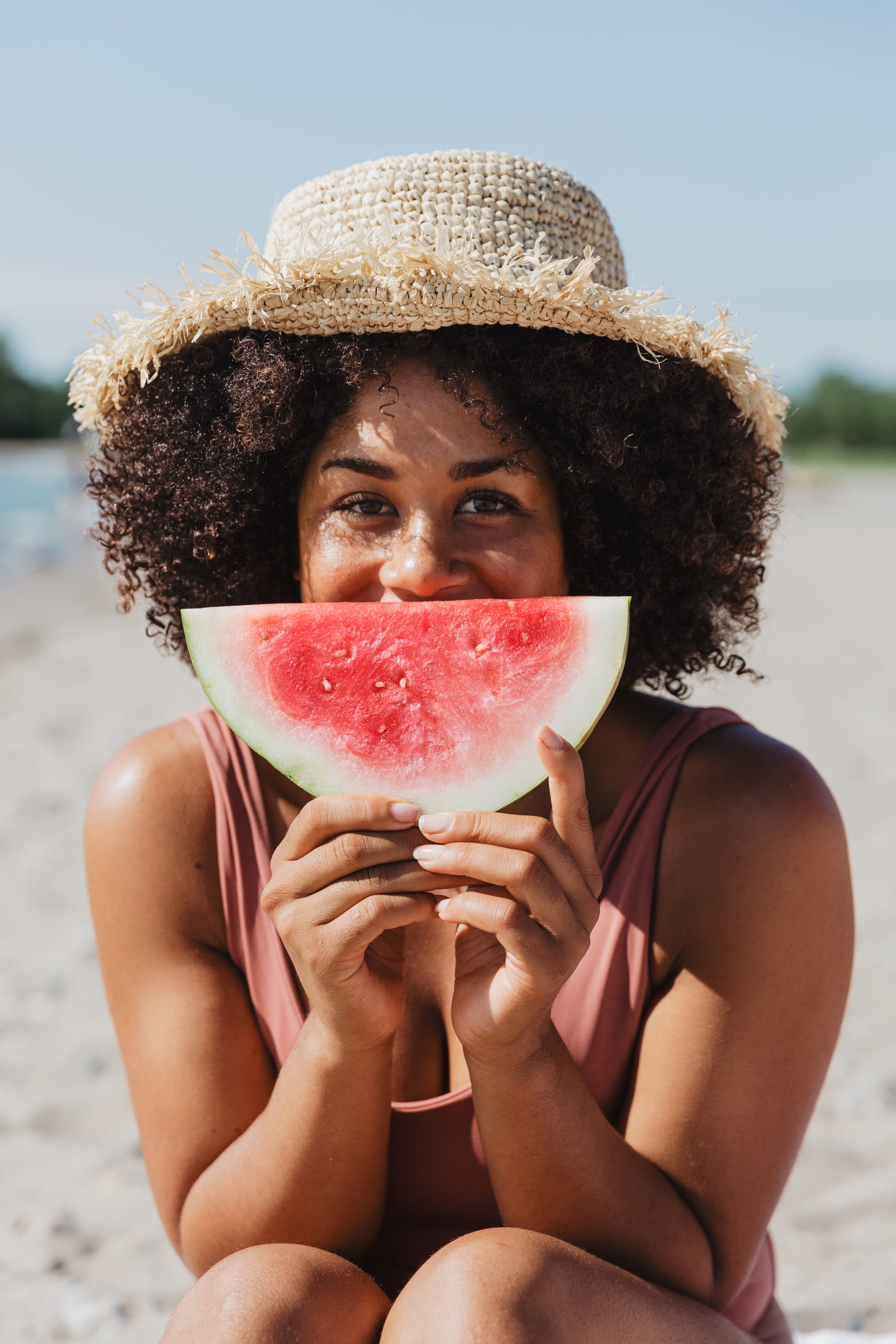 files/young-woman-holds-watermelon-slice-on-sunny-beach.jpg